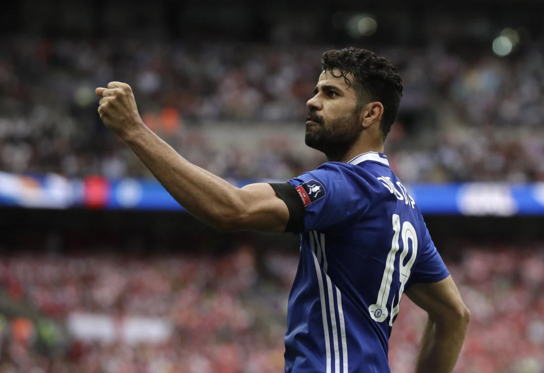 In this Saturday, May 27, 2017 file photo, Chelsea's Diego Costa celebrates scoring his team's equalizer during their English FA Cup final soccer match against Arsenal at the Wembley stadium in London. Atletico Madrid and Chelsea on Thursday, Sept. 17 say they have reached an agreement for the transfer of striker Diego Costa to the Spanish club. Chelsea says it gave Costa permission to travel to Madrid to undergo a medical and finalize the contract details with his former club. (AP )