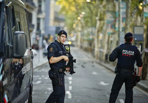 Armed police officers patrol a deserted street in Las Ramblas, in Barcelona, Spain, Friday, Aug. 18, 2017. (AP)