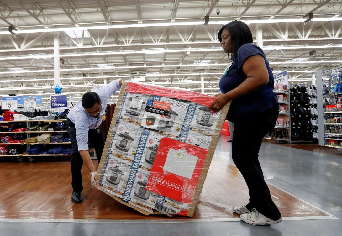 Employees prepare a display ahead of Black Friday sales at a Walmart store in Chicago, Illinois. (Reuters)