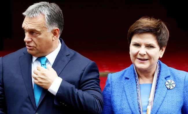 Hungarian PM Viktor Orban meets his Polish counterpart Beata Szydlo at the Polish Prime Minister Chancellery in Warsaw, on Friday. (Reuters)