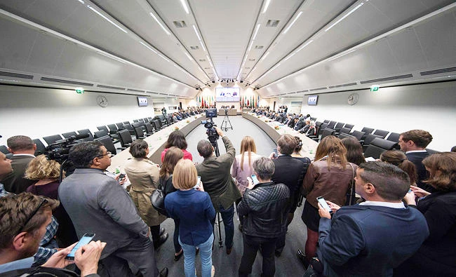 Journalists follow the Organization of the Petroleum Exporting Countries (OPEC) meeting in Vienna, on Friday where the OPEC members reviewed progress on their 2016 agreement to curb oil output. (AFP)