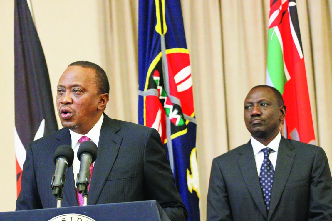 Kenya’s President Uhuru Kenyatta, left, accompanied by Deputy President William Ruto speaks to the media at State House in Nairobi, Kenya on Thursday. (AP)
