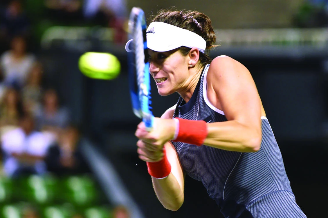 Garbine Muguruza of Spain hits a return against Caroline Garcia of France during their women's singles quarter-final match at the Pan Pacific Open tennis tournament
in Tokyo on Friday. (AFP)