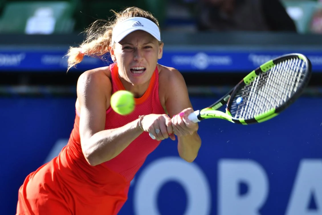 Caroline Wozniacki of Denmark hits a return against Garbine Muguruza of Spain during their women’s singles semifinal match at the Pan Pacific Open tennis tournament in Tokyo on September 23, 2017. (AFP)