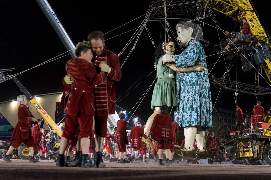 Animated marionettes called 'The Little Girl Giant' and 'The Grandmother Giant' by French street theatre company Royal de Luxe parade through the streets of Carouge during their 'The Saga of the Giants' performance on September 29, 2017 in Geneva. The Royal de Luxe Company are to perform in Geneva until October 1, 2017. - / AFP / Fabrice COFFRINI