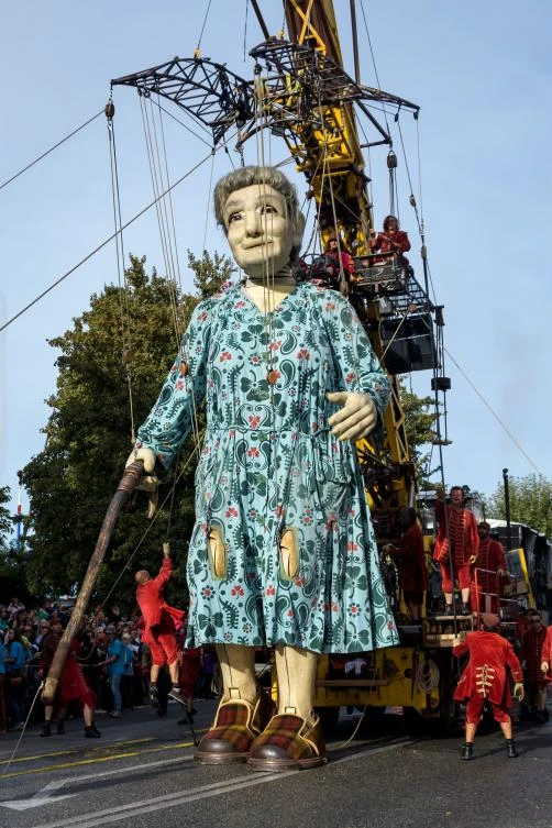 A 7,30 meters high giant animated puppet representing a grandmother created by French street theatre company Royal de Luxe, makes her way during the last act of 'The Saga of the Giants' a three days street performance gathering hundred thousand spectators, on October 1 2017 in Geneva. - / AFP / Fabrice COFFRINI