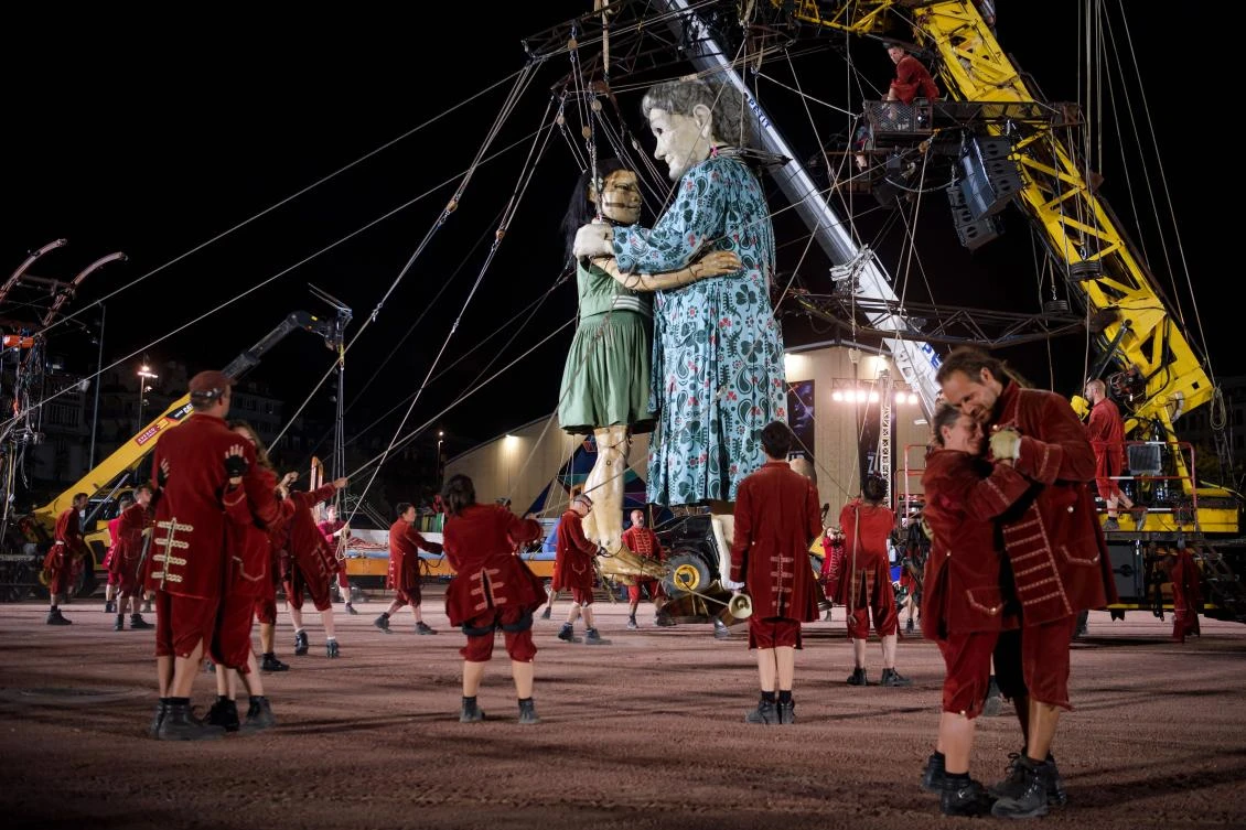 Animated marionettes called 'The Little Girl Giant' and 'The Grandmother Giant' by French street theatre company Royal de Luxe parade through the streets of Carouge during their 'The Saga of the Giants' performance on September 29, 2017 in Geneva. The Royal de Luxe Company are to perform in Geneva until October 1, 2017. - / AFP / Fabrice COFFRINI