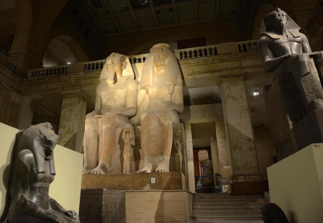 A picture taken on October 28, 2017, shows a limestone sculpture of Egyptian Pharaoh Amenhotep III, the ninth pharaoh of the Eighteenth Dynasty, with his wife Tiye, and their three daughters on display at the Egyptian Museum during the "Night of Art" exhibit in the capital Cairo. / AFP / MOHAMED EL-SHAHED