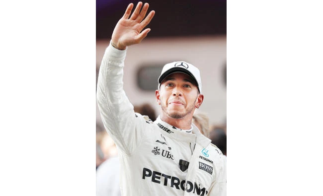 Lewis Hamilton of Mercedes waves after getting pole position in qualifying on Saturday. (Reuters)