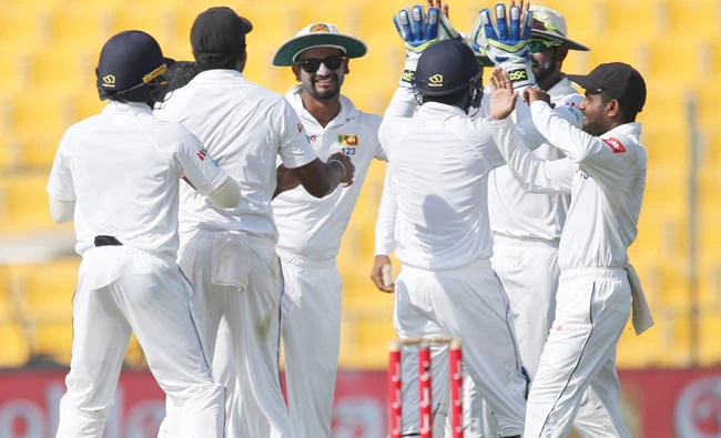 Sri Lanka players celebrate the dismissal of Pakistan’s Asad Shafiq during the third day at the first Test cricket match in Abu Dhabi Saturday. (AP)
