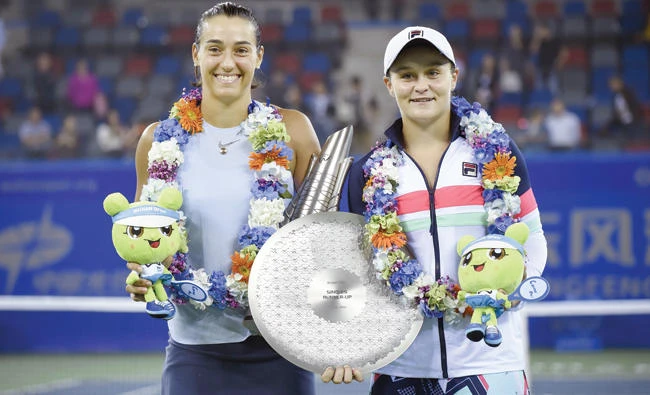 Tournament winner Caroline Garcia of France, left, and second place Ashleigh Barty of Australia after the women's singles final match at the WTA Wuhan Open tennis tournament in Wuhan on Saturday. (AFP)