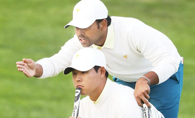 India’s Anirban Lahiri of the International Team and teammate Si Woo Kim of South Korea line up a putt during the fourball matches of the Presidents Cup at Liberty National Golf Club on Saturday in Jersey City, New Jersey. (AFP)