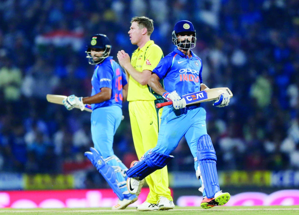 Indian cricket players Ajinkya Rahane, right, and Rohit Sharma run between the wickets during the fifth One-Day International cricket match between India and Australia in Nagpur, India, Sunday. (AP)