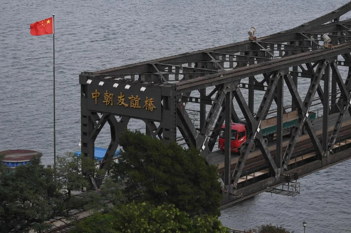 This file picture taken on September 4, 2017 shows a truck returning from North Korea on the Friendship Bridge at the Chinese border city of Dandong, in China's northeast Liaoning province, opposite the North Korean town of Sinuiju. China has ordered North Korean companies in the country to shut down by January as it applies UN sanctions imposed following Pyongyang's sixth nuclear test, the commerce ministry said on September 28, 2017. (AFP)