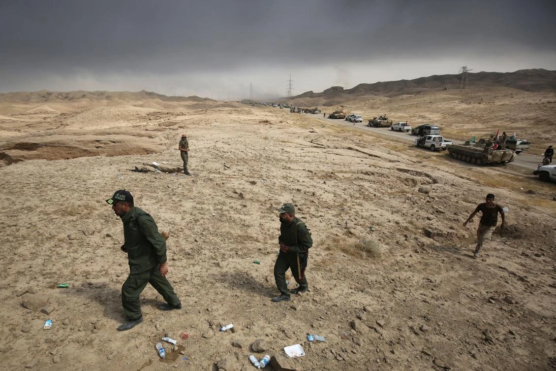 Iraqi forces and Hashed al-Shaabi (Popular Mobilisation units) members hold a position as they advance towards the Islamic State (IS) group's stronghold of Hawija on September 30, 2017 to recapture the town from the jihadists. Iraqi forces on September 29 launched an assault on the northern town of Hawija, one of the last bastions in the country still held by the Islamic State group, which is also under attack in neighbouring Syria. (AFP)