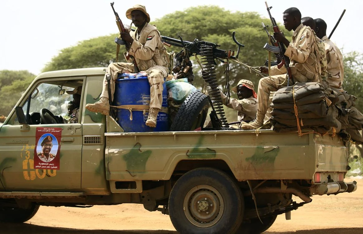 Sudanese members of the Rapid Support Forces, a paramilitary force backed by the Sudanese government to fight rebels and guard the Sudan-Libya border, ride in the back of a Toyota pickup truck as they prepare to receive President Omar Al-Bashir during his visit to the village of Umm Al-Qura, northwest of Nyala in South Darfur province, on September 23, 2017. (File photo by AFP)