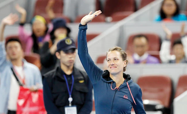 Barbara Strycova of the Czech Republic waves to spectators after her opponent, Garbine Muguruza of Spain, retired from their women's singles match in the China Open tennis tournament at the Diamond Court in Beijing Monday. (AP)