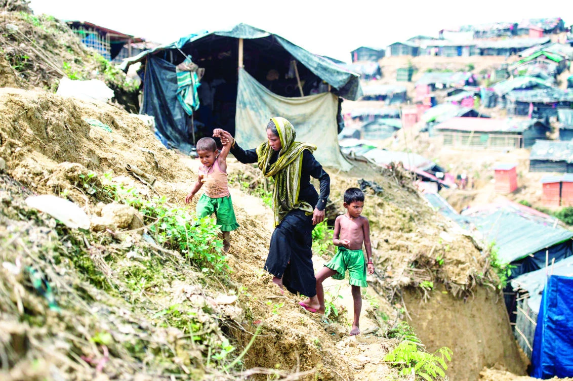 Rohingya Muslim refugees walk through Balukhali refugee camp on Monday. The UN says more than 14,100 children are at risk of dying from malnutrition in wretched camps where half a million mainly Rohingya refugees depend entirely on charities for survival. (AFP)
