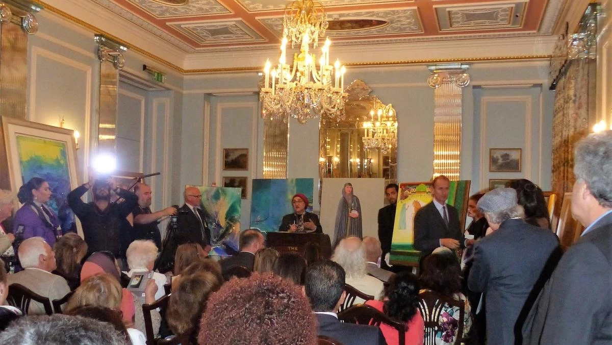 A room full of well-heeled people sat under chandeliers as they bid for artworks.