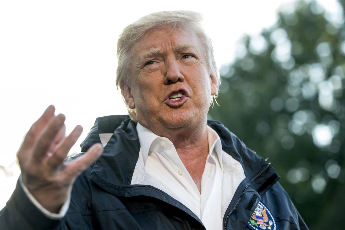 President Donald Trump talks to reporters as he walks to board Marine One on the South Lawn of the White House in Washington, Tuesday, October 3, 2017. (AP)