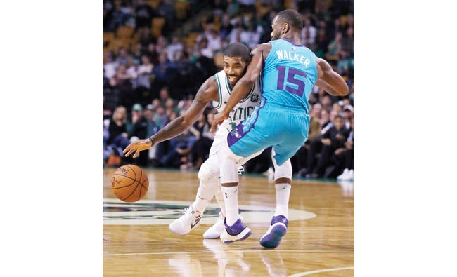 Boston Celtics guard Kyrie Irving, left, tries to drive past Charlotte Hornets guard Kemba Walker (15) during the first quarter of an NBA preseason basketball game in Boston Monday. (AP)