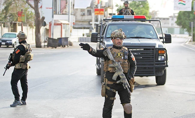 A photo taken on September 25, 2017 shows members of SWAT (Special Weapons and Tactics) security forces, affiliated to the Iraqi Interior Ministry, deploying in the streets of the northern city of Kirkuk during the vote on the Kurdish independence on September 25, 2017. (AFP)