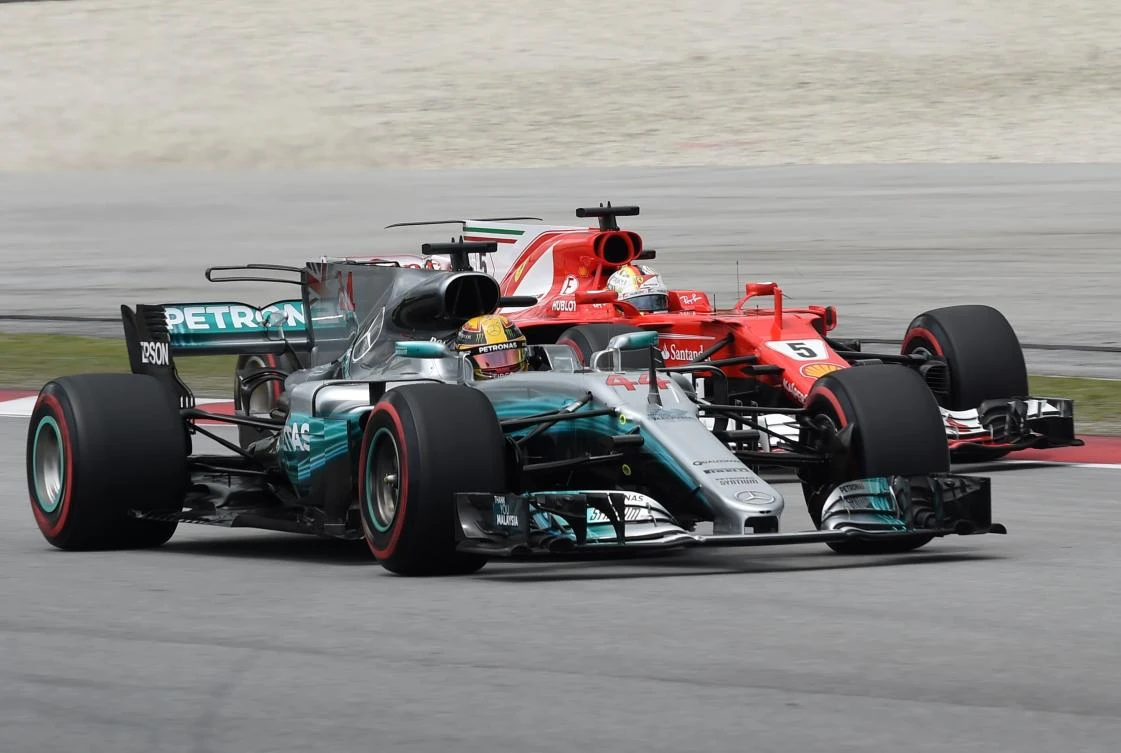 This file photo taken on September 30, 2017 shows Mercedes’ British driver Lewis Hamilton (front) and Ferrari’s German driver Sebastian Vettel driving during the third practice session of the Formula One Malaysia Grand Prix at the Sepang circuit near Kuala Lumpur. (AFP/Roslan Rahman)
