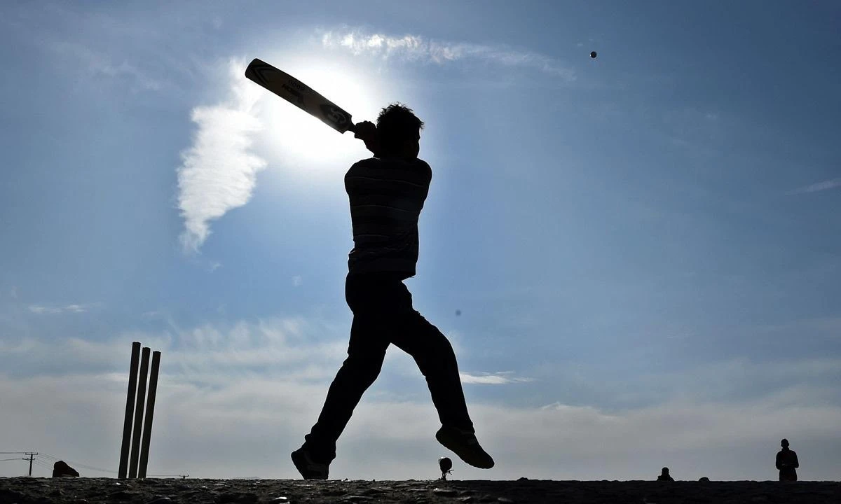 An Afghan street cricket player bats during a friendly game in front of the ruined Darul Aman Palace in Kabul. (File photo by AFP)