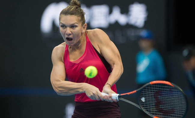Simona Halep of Romania hits a return during her women's singles match against Maria Sharapova of Russia at the China Open tennis tournament in Beijing on Wednesday. (AFP)