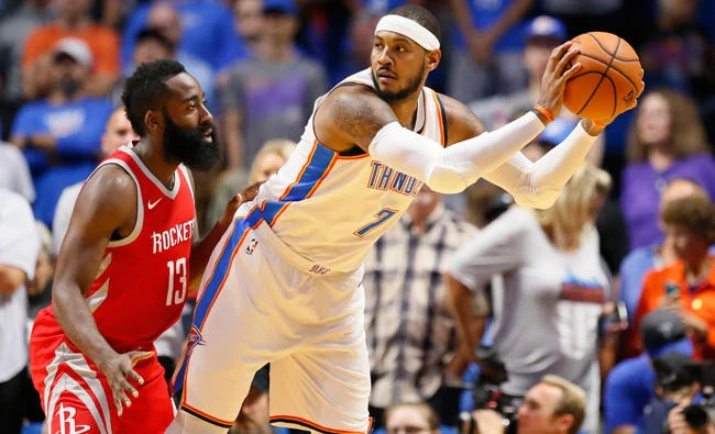 Oklahoma City Thunder forward Carmelo Anthony is guarded by Houston Rockets guard James Harden during the first quarter of an NBA preseason basketball game in Tulsa, Oklahoma, Tuesday. (AP)