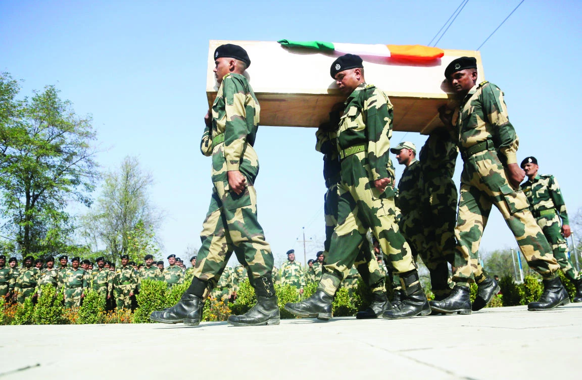 Indian Border Security Force (BSF) soldiers carry the coffin of their slain colleague during a wreath-laying ceremony on the outskirts of Srinagar, Indian-controlled Kashmir, Wednesday. The border guard officer was killed along with three suspected militants when a group of rebels fighting Indian rule stormed a paramilitary camp near the airport in disputed Kashmir early Tuesday. (AP)