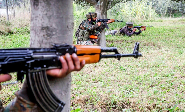 Indian army soldiers take position inside an apple orchard near the site of gunbattle in Pulwama, about 35 Kilometers south of Srinagar, Indian controlled Kashmir, in this Aug. 26, 2017 photo. (AP)