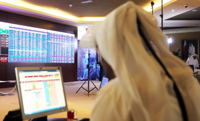 This file photo taken on July 31, 2017 shows a Qatari trader following the stock market at the Qatari stock exchange in Doha. (AFP)