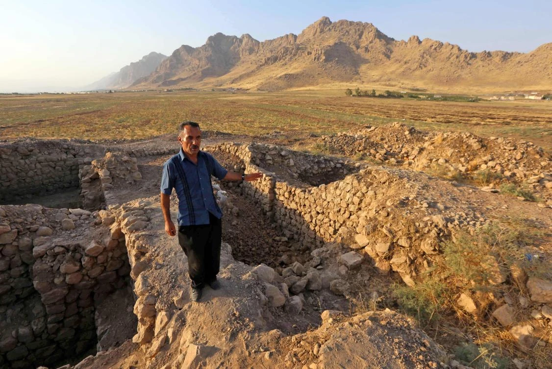 Above, a man inspects a historical site at the ancient city of Qalatga Darband, which is believed to have been founded in 331 BC by Alexander the Great. (AFP)