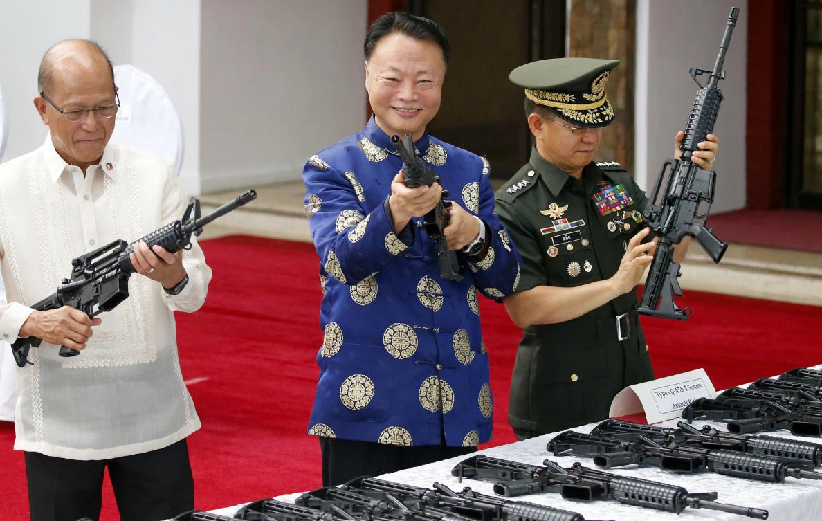 From left, Philippine Defense Secretary Delfin Lorenzana, Chinese Ambassador to the Philippines Zhao Jianhua, Philippine Armed Forces Chief Gen. Eduardo Ano, inspect Chinese-made CQ-A5b assault rifles during turnover ceremony Thursday, Oct. 5, 2017 in Camp Aguinaldo in suburban Quezon city northeast of Manila, Philippines. (AP)