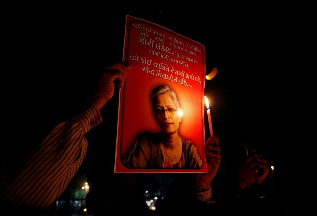 People hold placards and candles during a vigil for Gauri Lankesh, a senior Indian journalist who according to police was shot dead outside her home on Tuesday by unidentified assailants in the southern city of Bengaluru, in Ahmedabad, India, September 6, 2017. (File photo by Reuters)
