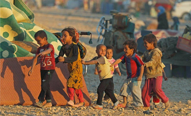 Children play inside a refugee camp on Wednesday in Ain Issa, Syria. (Reuters)