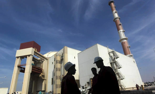 Iranian workers stand in front of the Bushehr nuclear power plant in Iran in this October 26, 2010 file photo. US President Donald Trump is expected to reveal his decision on the future of the Iran nuclear deal in the coming days. (REUTERS/Mehr News Agency/Majid Asgaripour/Files)