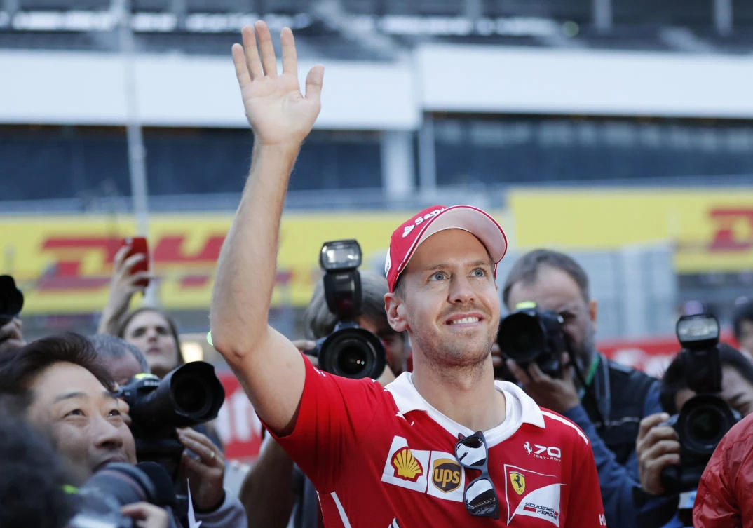 Ferrari driver Sebastian Vettel of Germany waves to fans during a fan meeting ahead of the Japanese Formula One Grand Prix at the Suzuka Circuit in Suzuka, central Japan. (AP)