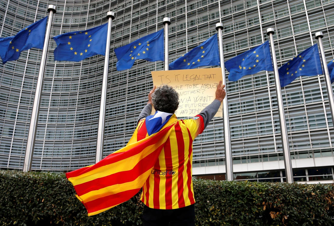 Catalan Raimon Castellvi wears a flag with an Estelada (Catalan separatist flag) as he protests outside the European Commission in Brussels. (Reuters)
