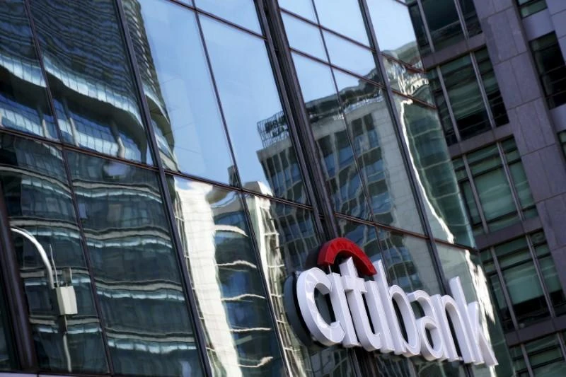 Above, reflections are seen on the glass facade of a Citibank branch in Beijing, China. (Reuters)