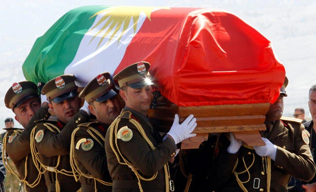 The coffin of former Iraqi president Jalal Talabani is covered with a Kurdish flag at Sulaimaniya Airport, Iraq, on October 6, 2017. (REUTERS/Ako Rasheed)