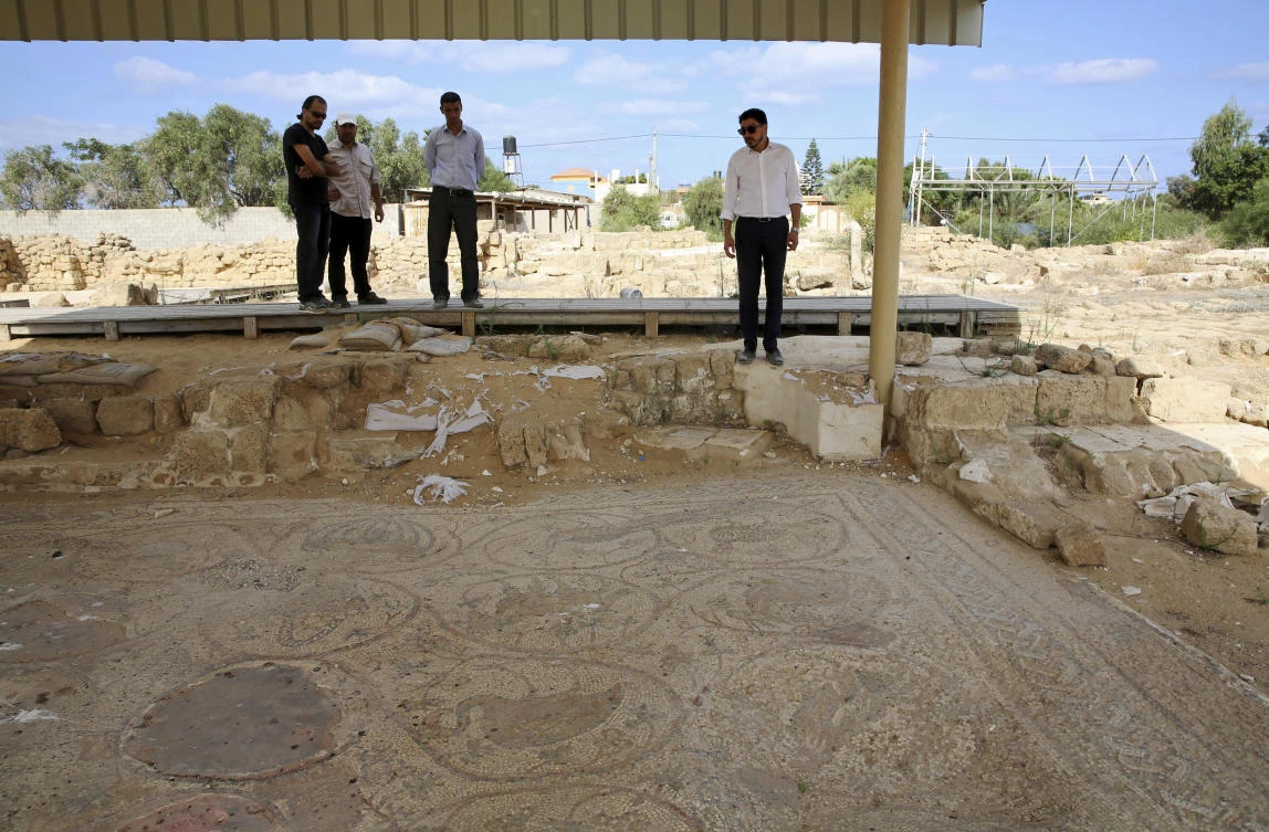 Junaid Sorosh-Wali, right, a UNESCO official, inspects the remains of a mosaic at St. Hilarion monastery, a site of early Christianity, in Nusseirat, central Gaza Strip. (AP Photo/Adel Hana)
