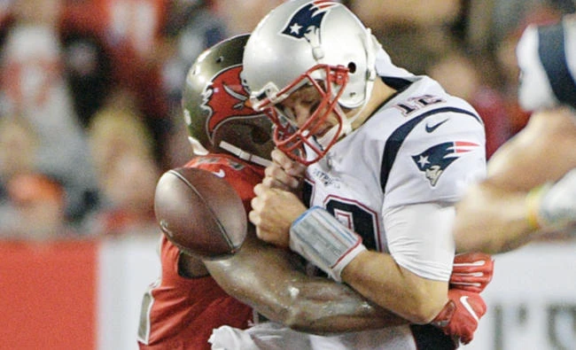 New England Patriots quarterback Tom Brady (12) fumbles after being hit by Tampa Bay Buccaneers outside linebacker Adarius Glanton during the third quarter of an NFL football game in Tampa, Fla. on Friday. (AP)