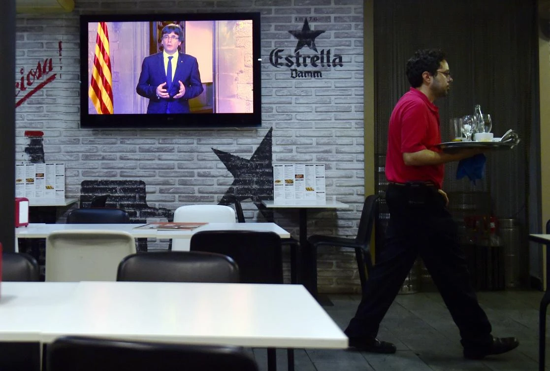 Catalan president Carles Puigdemont delivers an institutional statement during a television broadcast. Puigdemont has threatened to declare independence “within days.” (AFP)