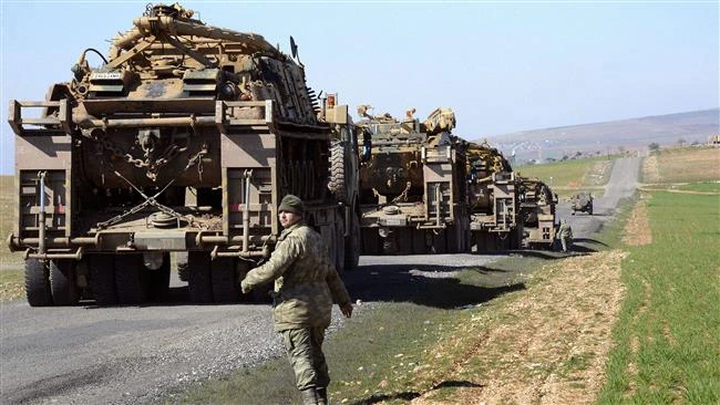 Turkish Army vehicles and tanks move near the Syrian border. (AFP)