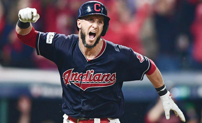 Cleveland Indians’ Yan Gomes celebrates after hitting a game-winning single off New York Yankees relief pitcher Dellin Betances in the 13th inning of Game 2 of a baseball American League Division Series Friday in Cleveland. Austin Jackson scored on the play. The Indians won 9-8. (AP)
