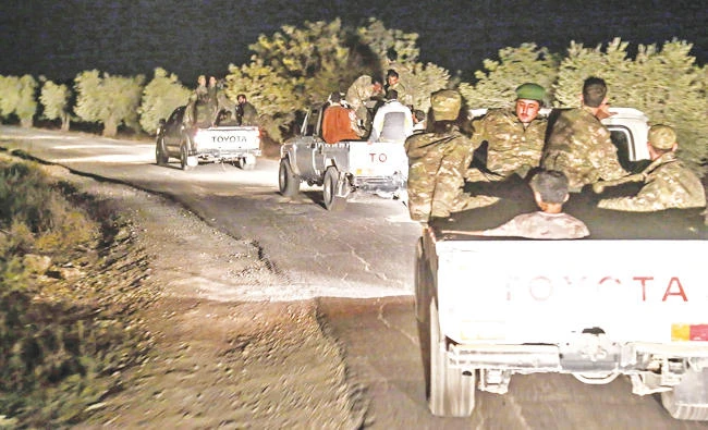 Pro-Ankara Syrian opposition fighters riding pickup trucks near the village of Hawar Killis along the Syrian-Turkish border in Aleppo as they advance toward province. (AFP)