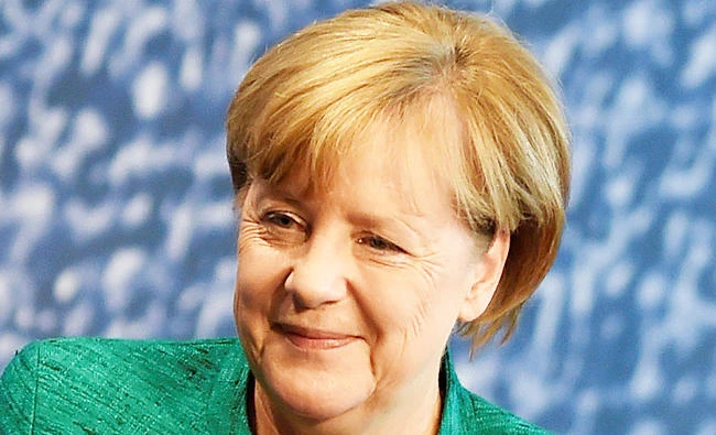 German Chancellor Angela Merkel gets a nutcracker doll as a gift after addressing a meeting of her conservative CDU's youth, the Junge Union (Young Union), in Dresden, Germany, on Saturday. (REUTERS)