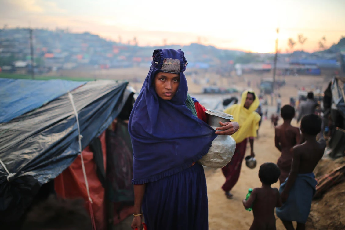 A Rohingya woman holds a vessel for drinking water at Palangkhali refugee camp in Cox's Bazar, Bangladesh, Wednesday, Oct. 4, 2017. More than half a million Rohingya have fled from Myanmar to Bangladesh in just over a month, the largest refugee crisis to hit Asia in decades. (AP)
